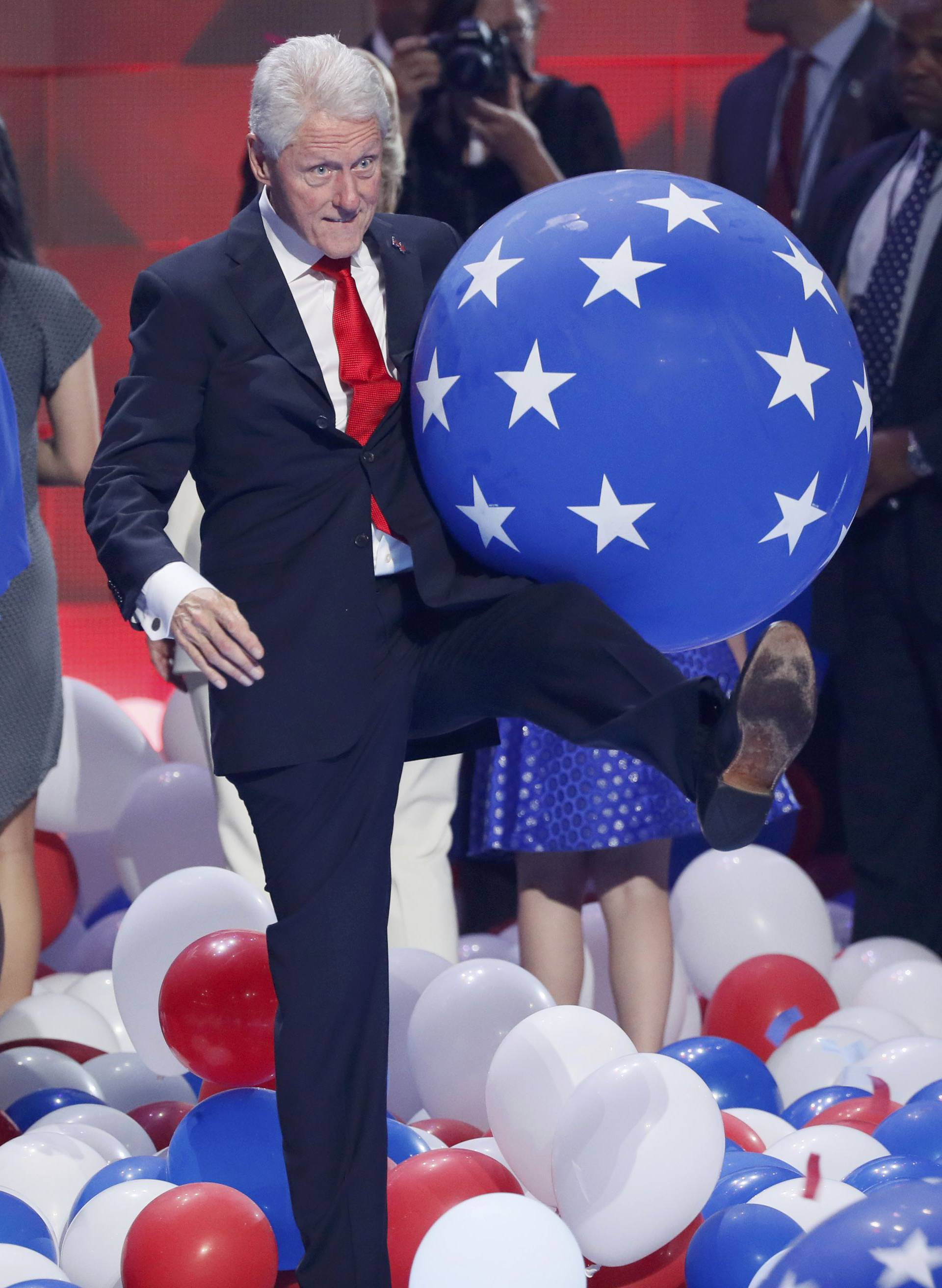 Former U.S. President Bill Clinton kicks ballons during celebrations onstage after his wife Democratic presidential nominee Hillary Clinton accepted the nomination on the fourth and final night at the Democratic National Convention in Philadelphia