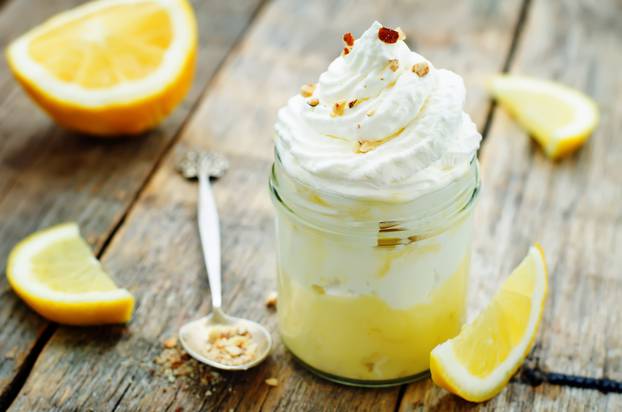 layered dessert with lemon cream, ice cream and whipped cream