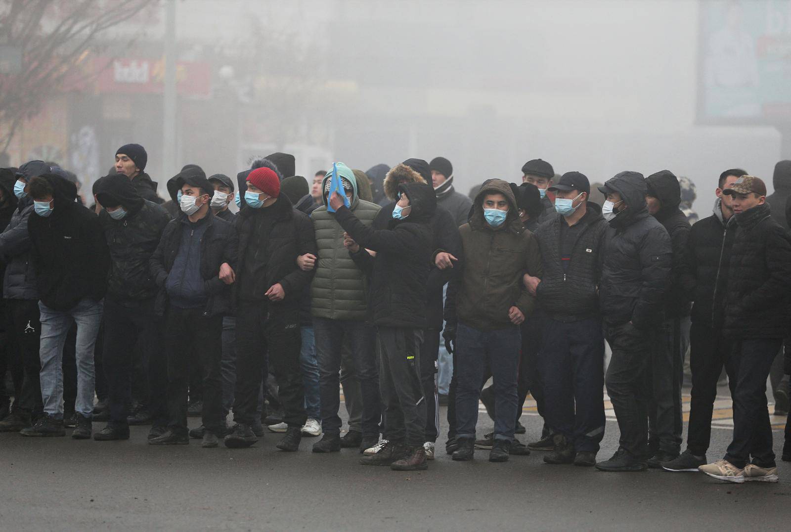 Demonstrators take part in a protest triggered by fuel price increase in Almaty