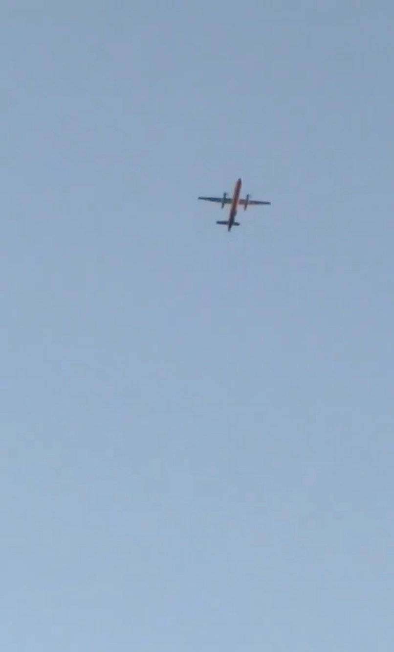 A Horizon Air Bombardier Q400, reported to be hijacked, flies over Fircrest, Washington