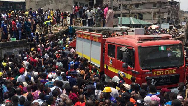 Rescue workers are seen at the site of a collapsed building containing a school in Nigeria's commercial capital of Lagos