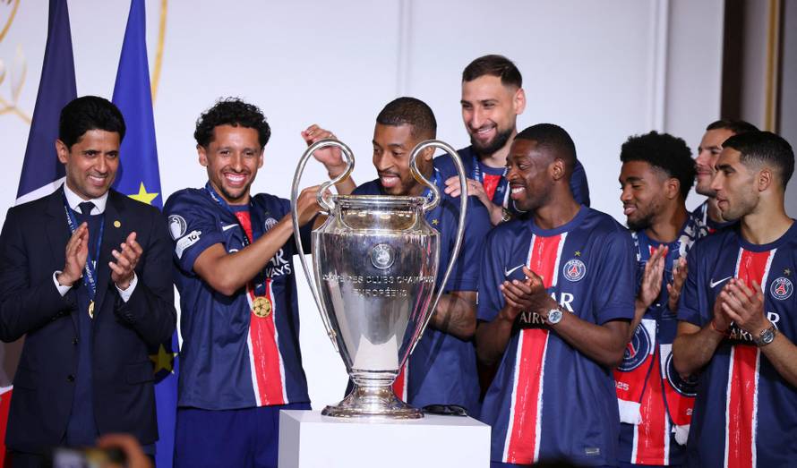 PSG president  Nasser Al-Khelaifi and players celebrate with the trophy after the team won the Champions League final soccer match between Paris Saint-Germain and Inter Milan