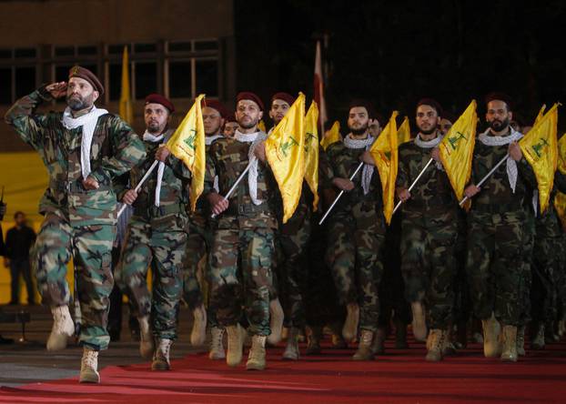 FILE PHOTO: Members of Hezbollah march with party's flags during a rally marking al-Quds Day, (Jerusalem Day) in Beirut