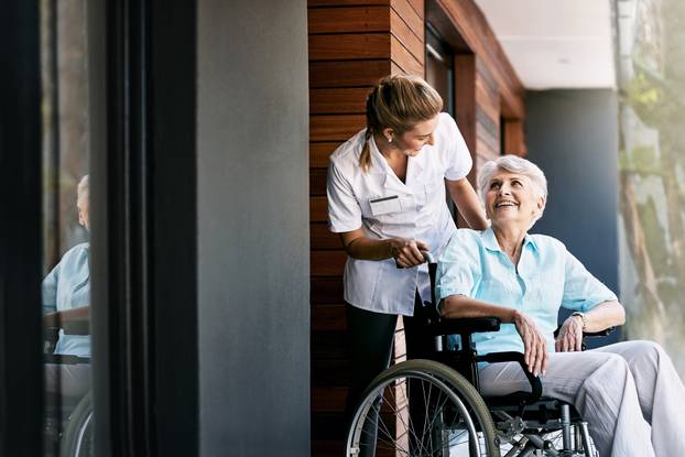 Nurse,,Talking,And,Senior,Woman,On,Wheelchair,For,Support,Or