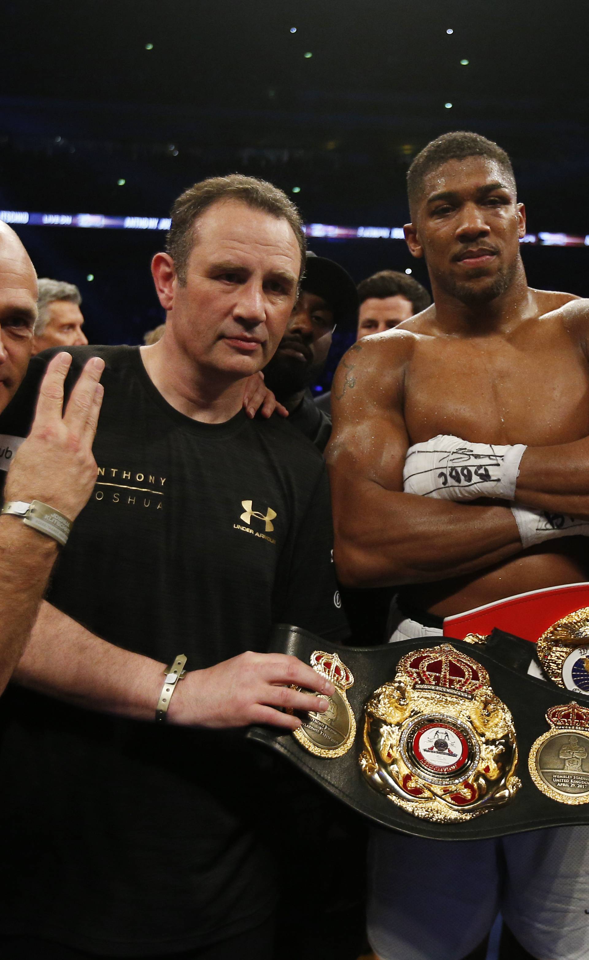 Anthony Joshua celebrates with trainer Robert McCracken, promoter Eddie Hearn and his corner after winning the fight