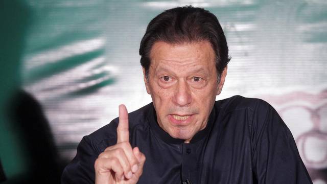 FILE PHOTO: Pakistan's former Prime Minister Imran Khan, gestures as he speaks to the members of the media at his residence in Lahore