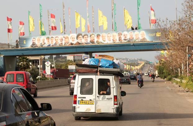 Displaced people make their way as they return to their homes after a 10-day ceasefire between Lebanon and Israel went into effect, near Sidon