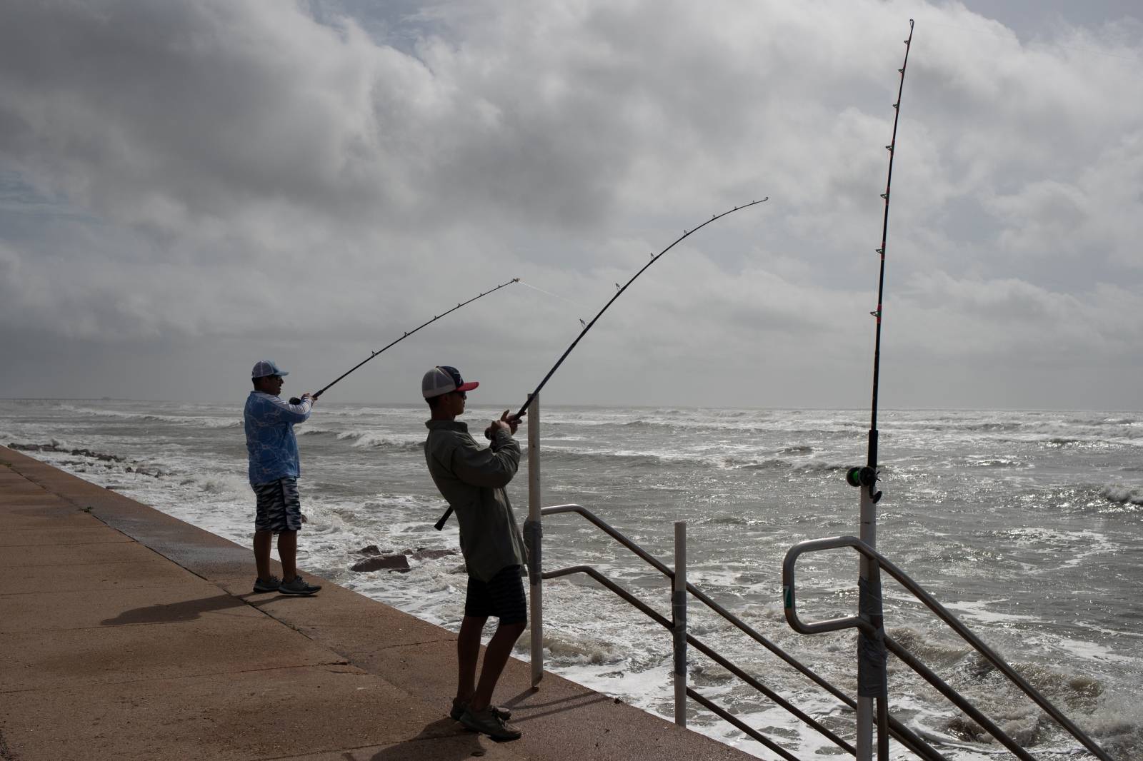 Father and son fish ahead of Hurricane Laura in Galveston, Texas