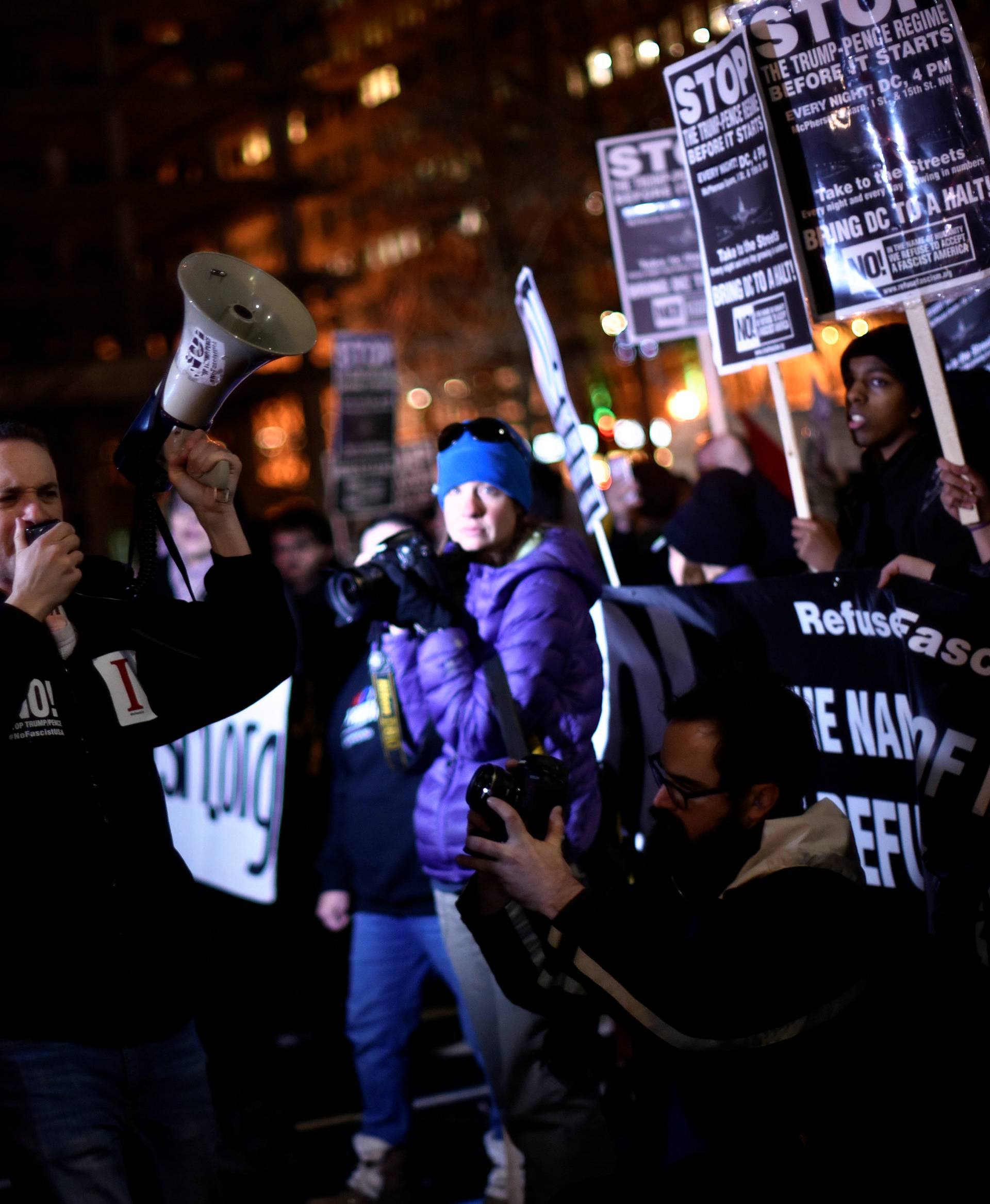 Demonstrators against U.S. president-elect Donald Trump march along the inaugural parade route outside the Trump International Hotel on Pennsylvania Avenue in Washington