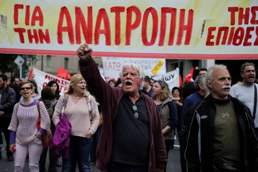 Demonstrators shouts slogans during a demonstration marking a 24-hour general strike against the latest round of austerity in Athens