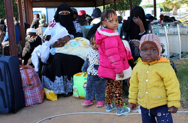 Migrants from Niger wait before they are deported by Libyan authorities, in Misrata