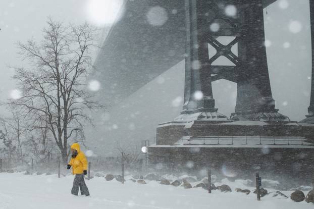 A person walks amid a major winter storm spreading across a large swath of the United States, in Brooklyn