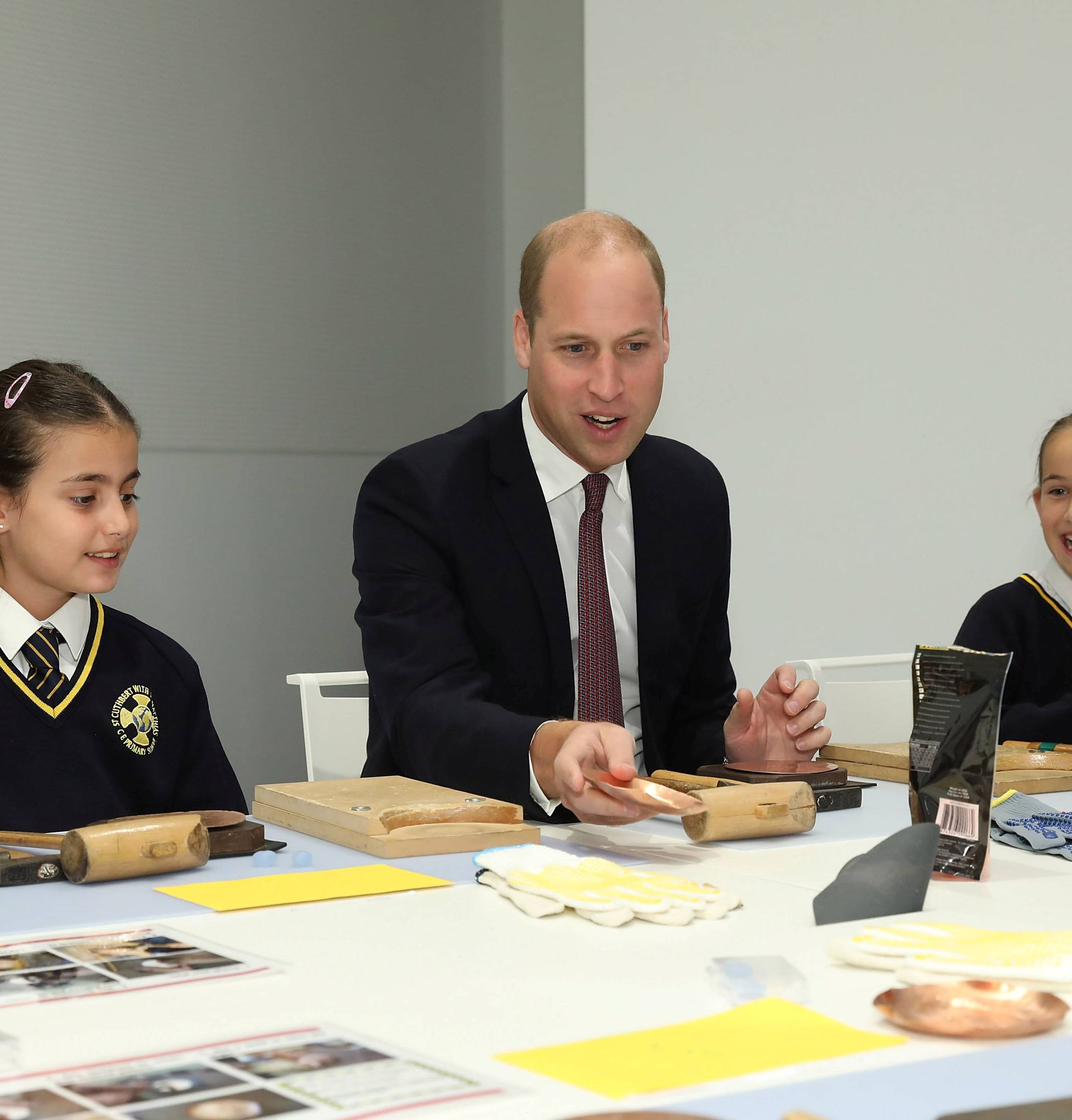 Britain's Prince William joins local school children from St Cuthbert with St Matthias CE Primary School at a copper beating workshop during the official opening of Japan House in London