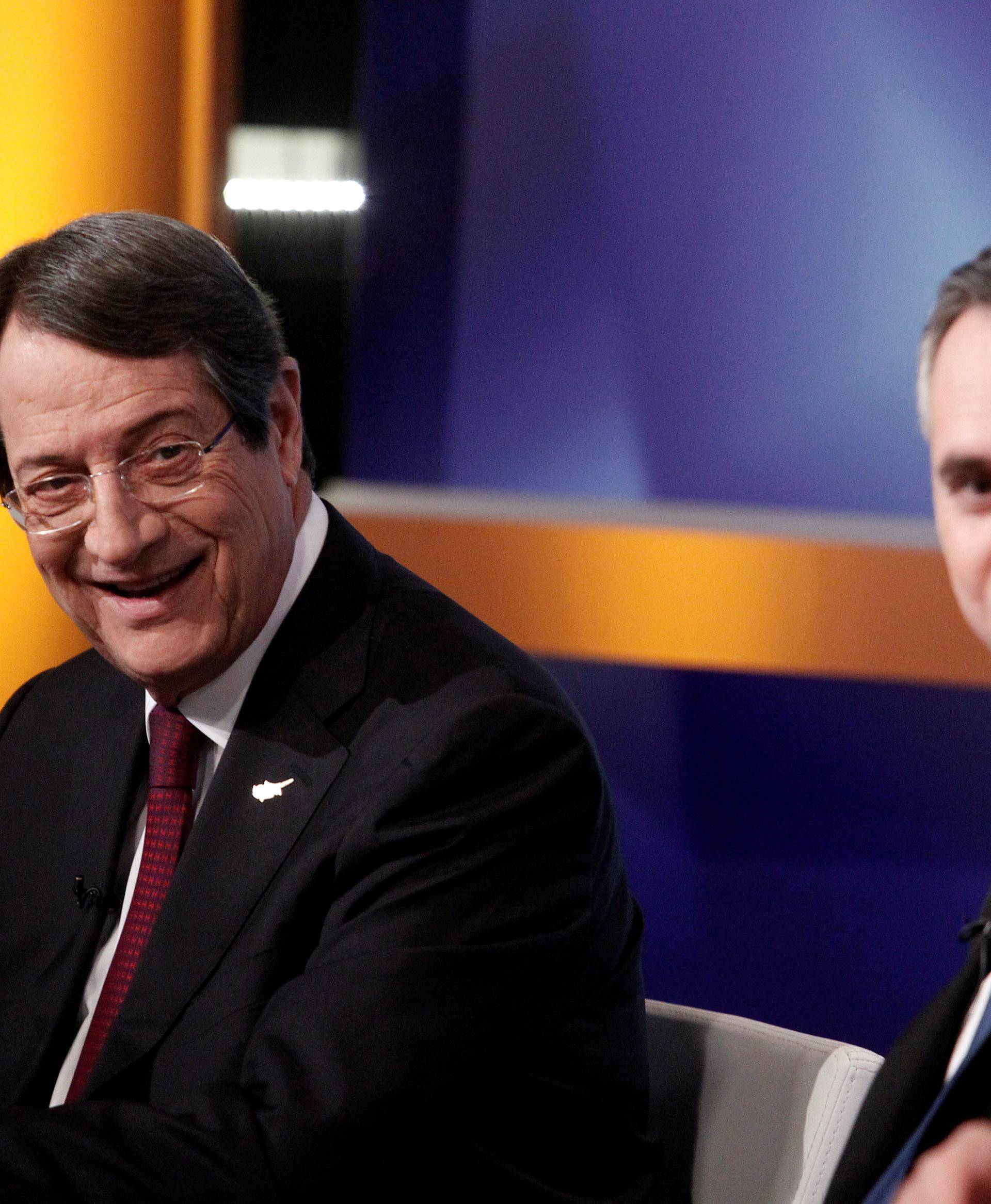 Cyprus Presidential candidate Nicos Anastasiades (L) of the right-wing Democratic Rally party and Nikolas Papadopoulos leader of the center-right DIKO party wait for a televised debate to go on air in Nicosia