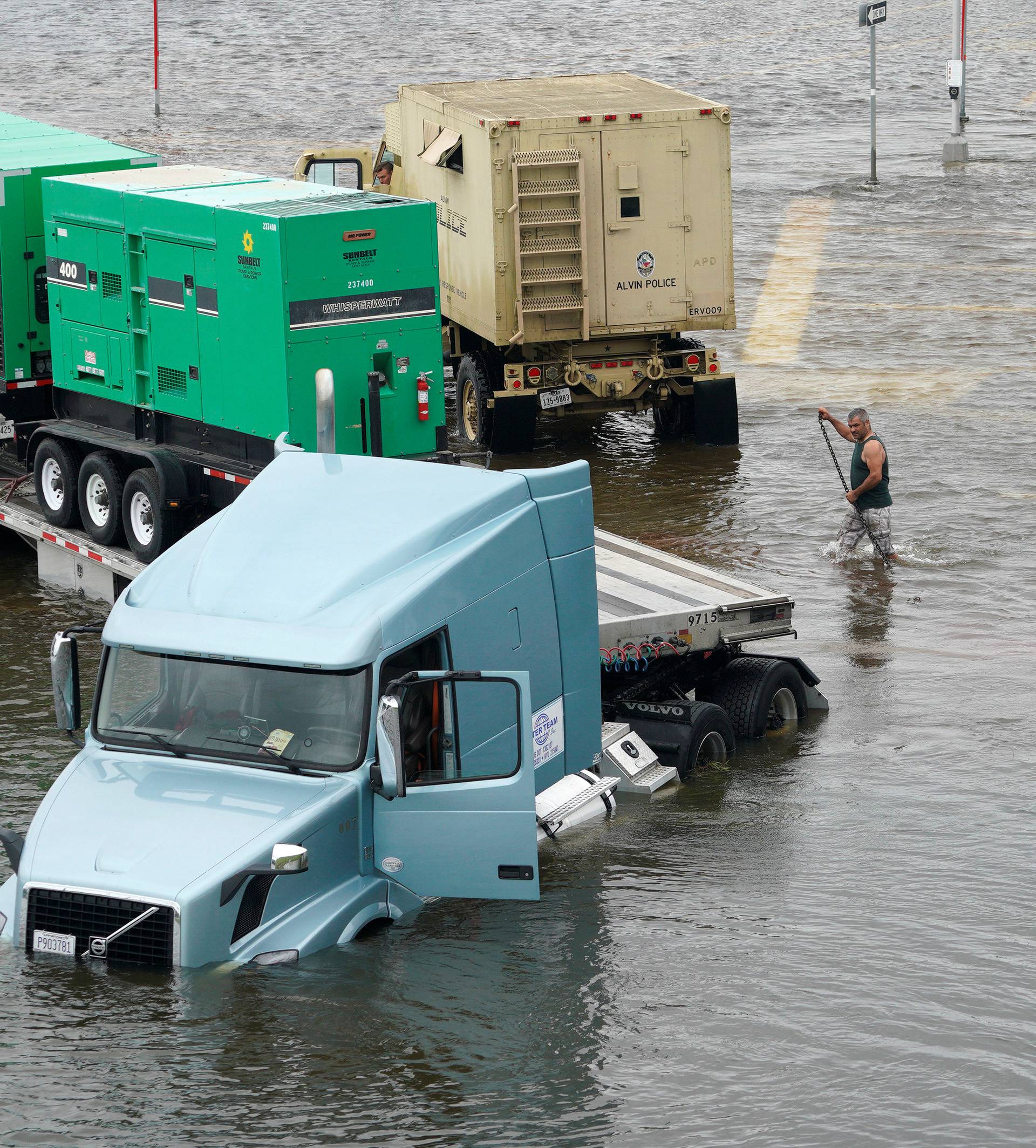 A truck carrying generators is stuck in Hurricane Harvey floodwaters near Alvin