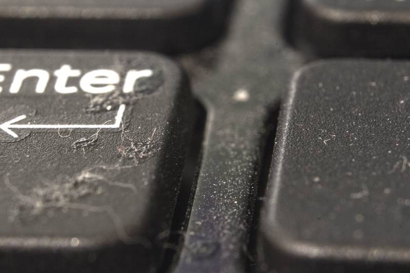 dirt and dust on the laptop buttons. close-up. back and foregrou