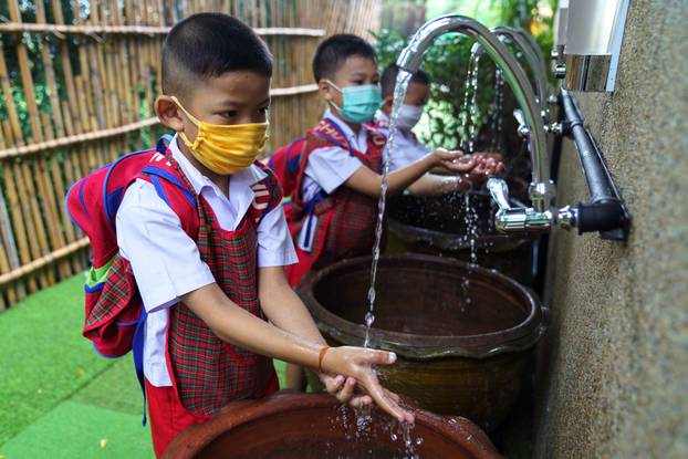 Thai kindergarten students rehearse social distancing and measures to prevent the spread of the coronavirus disease (COVID-19) in Bangkok