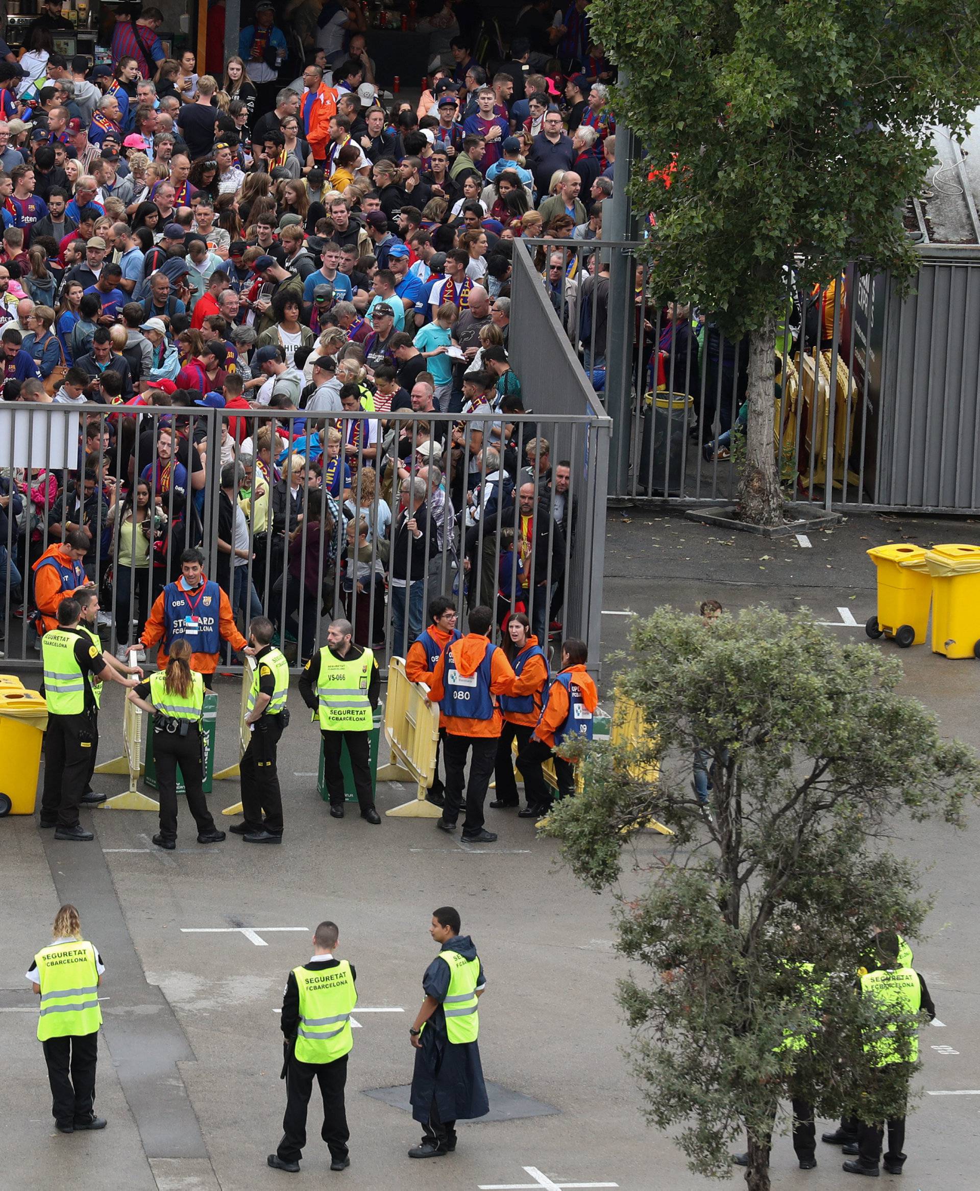 People wait outside Camp Nou stadium for news on whether the Spanish La Liga soccer match between Barcelona and Las Palmas will go ahead as planned in Barcelona