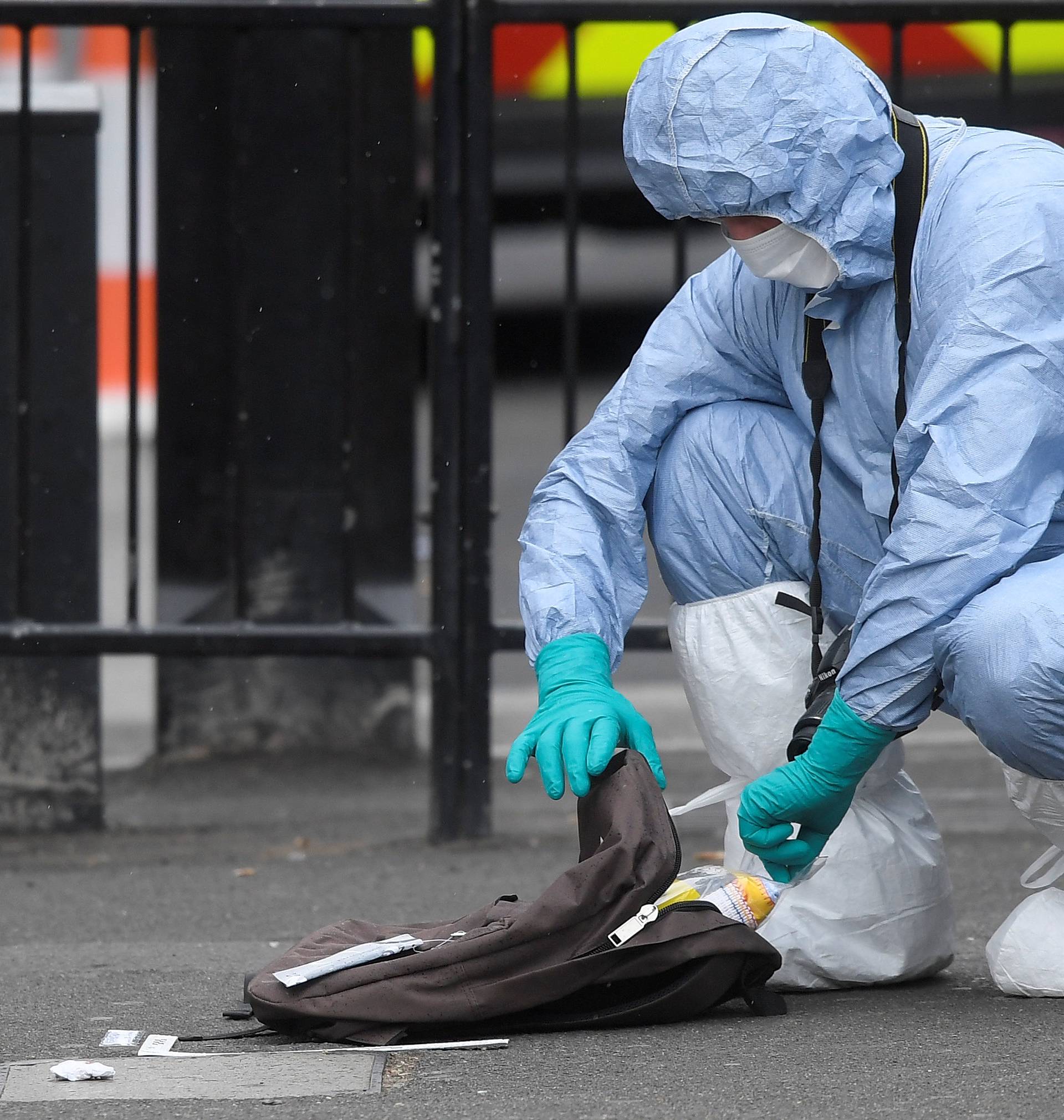 A forensic investigator opens a rucksack after man was arrested on Whitehall in Westminster in central London