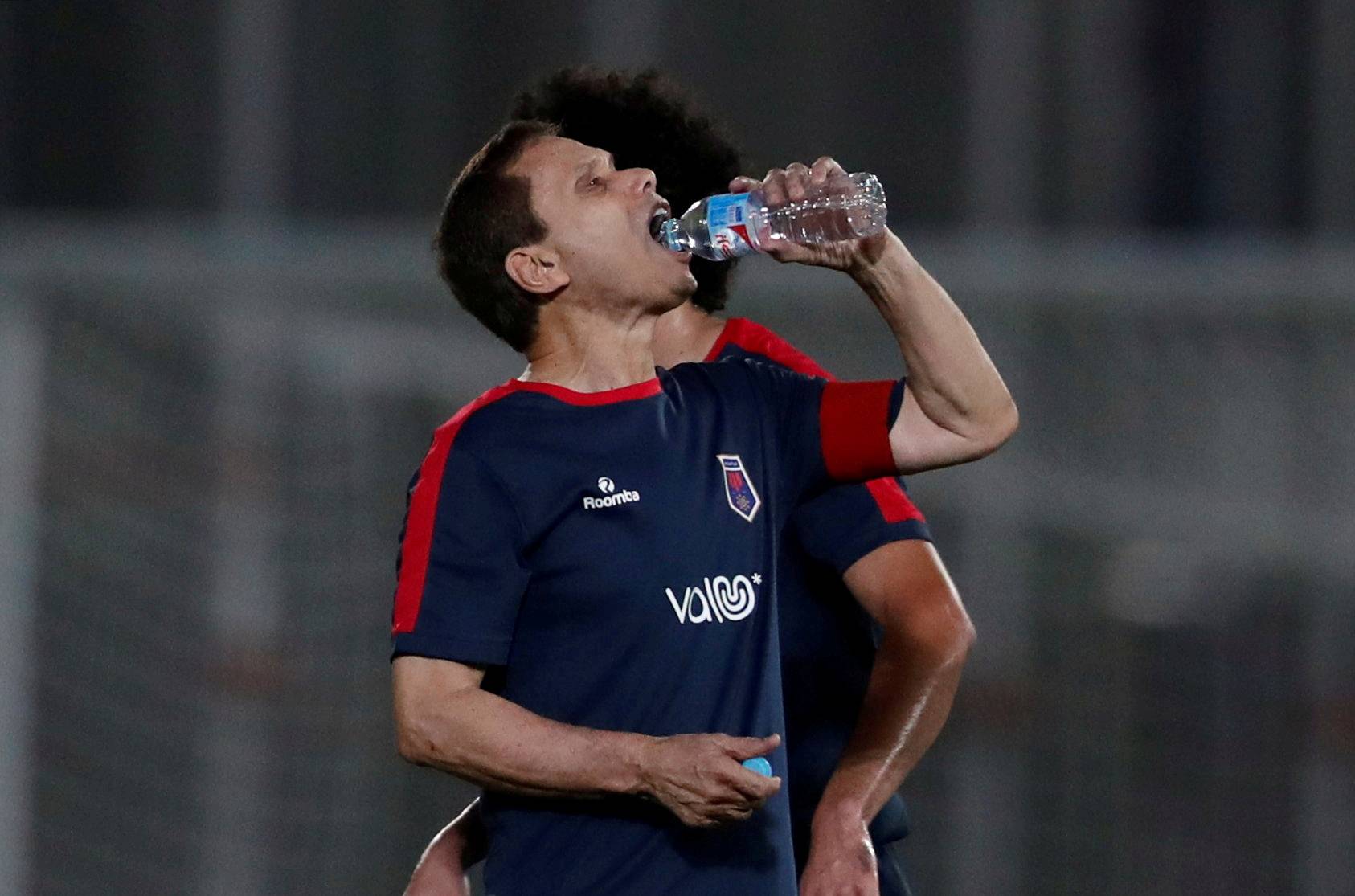 Ezzeldin Bahader, a 74-years-old Egyptian football player of 6th October Club drinks water during a soccer match against El Ayat Sports Club of Egypt's third division league at the Olympic Stadium in the Cairo suburb of Maadi