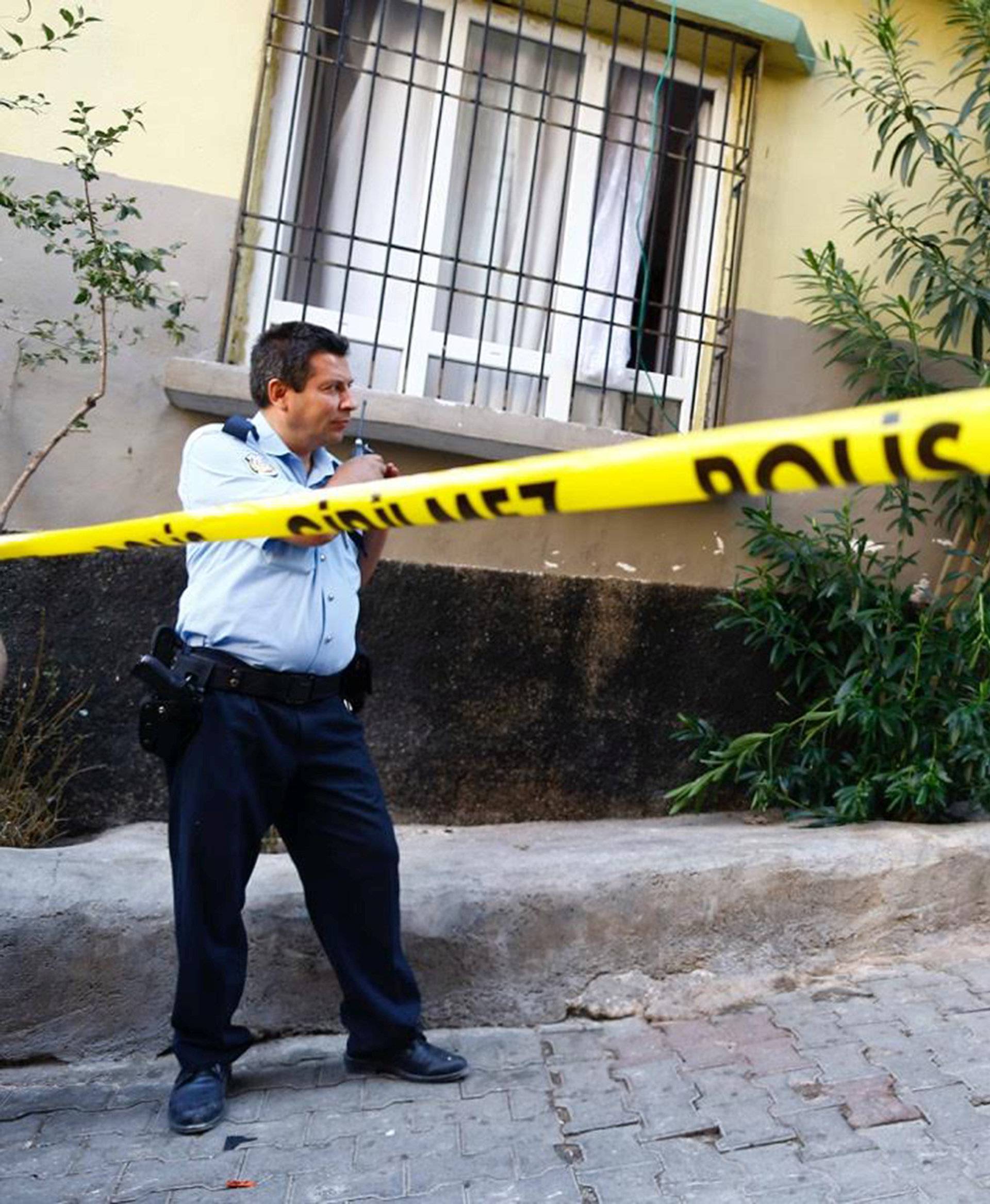 A police officer secures the scene of an explosion where a suspected suicide bomber targeted a wedding celebration in the Turkish city of Gaziantep