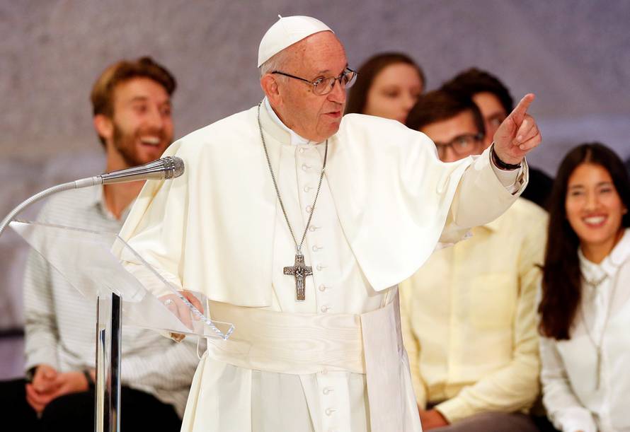 Pope Francis talks as he meets youth and the Synod Fathers at the Pope Paul VI hall in Vatican