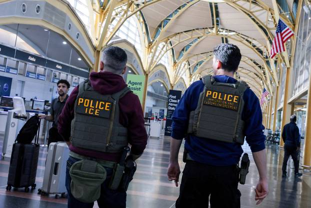 FILE PHOTO: U.S. Immigration and Customs Enforcement (ICE) agents patrol at Washington Reagan National Airport in Arlington, Virginia