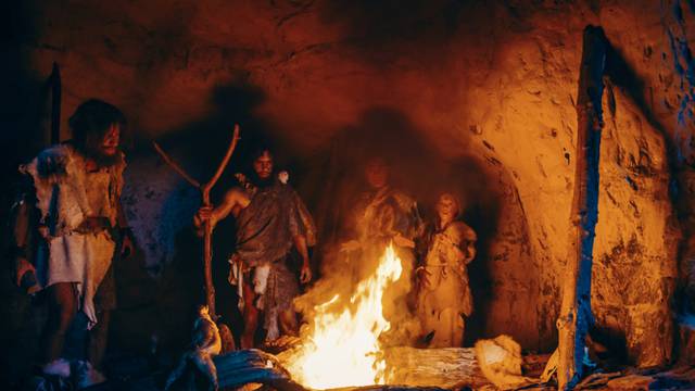 Tribe,Of,Prehistoric,Hunter-gatherers,Wearing,Animal,Skins,Stand,Around,Bonfire