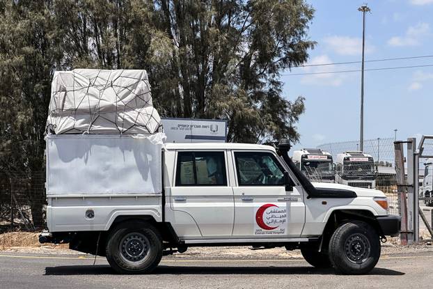 Vehicles loaded with goods enter the Kerem Shalom crossing between Israel and Gaza, on the Israeli side, on its way into Gaza