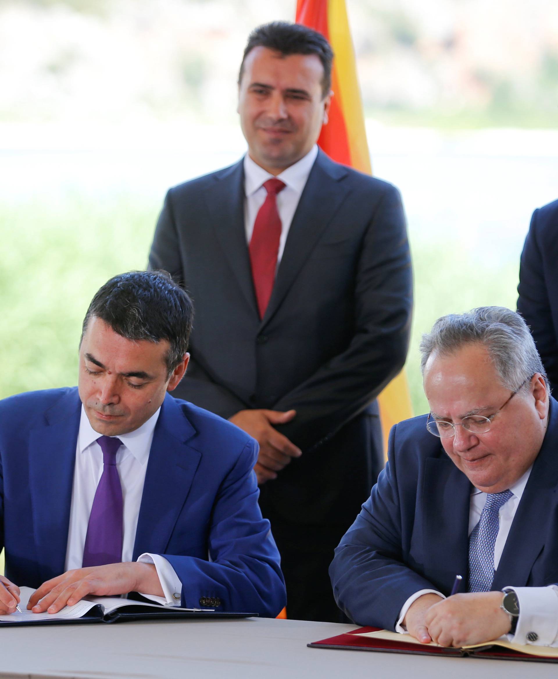 Greek Foreign Minister Kotzias and his Macedonian counterpart Dimitrov sign an accord to settle a long dispute over the former Yugoslav republic's name in the village of Psarades