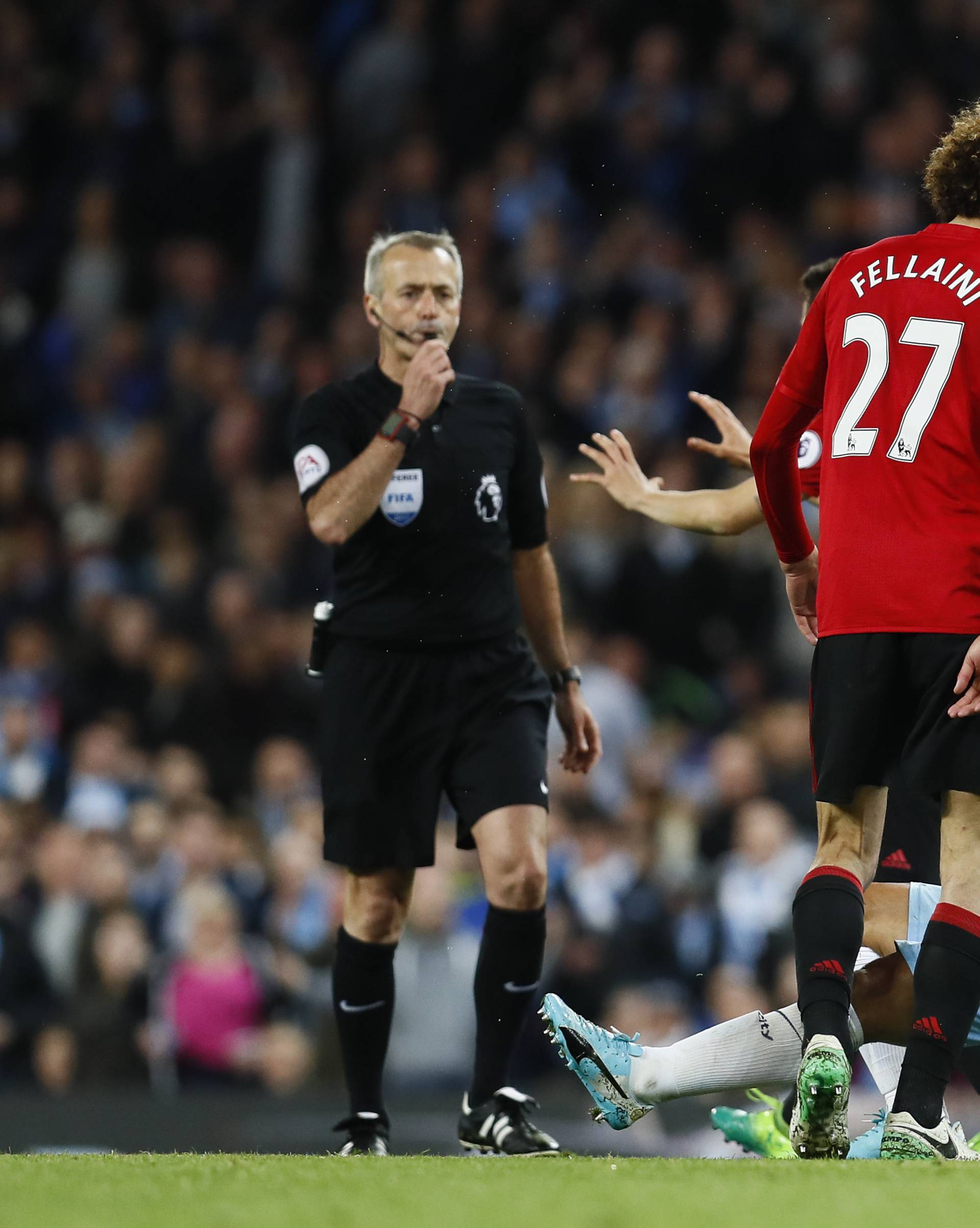 Manchester United's Marouane Fellaini clashes with Manchester City's Sergio Aguero before being sent off by referee Martin Atkinson