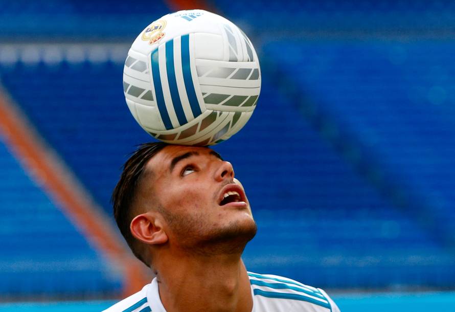 Real Madrid's new player Theo Hernandez heads the ball during his presentation at the Santiago Bernabeu Stadium in Madrid