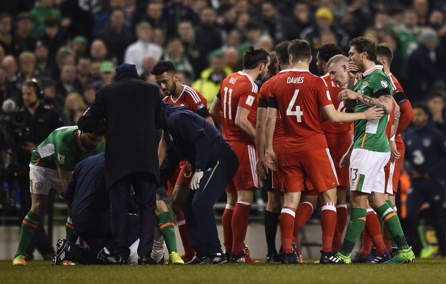 Republic of Ireland's Seamus Coleman receives medical attention
