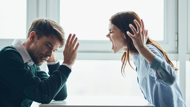 emotional man and woman sitting at the table conflict quarrel communication