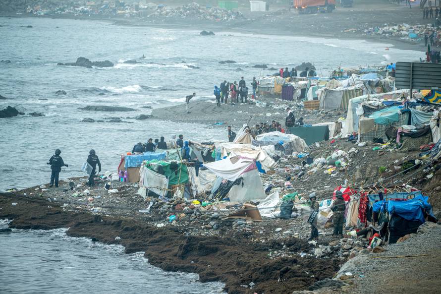 Spanish police clear an encampment of migrants at El Trampolin beach in the Spanish enclave of Ceuta