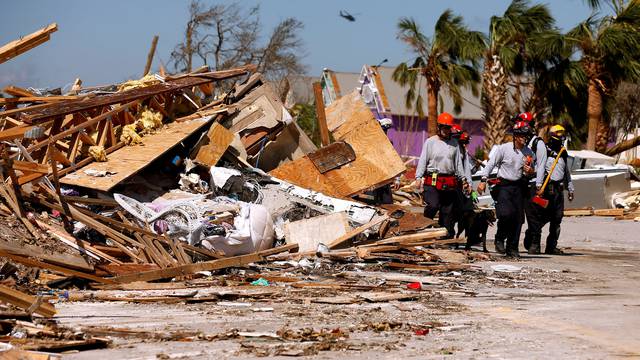 FILE PHOTO: Search and rescue crews walk past debris caused by Hurricane Michael in Mexico Beach