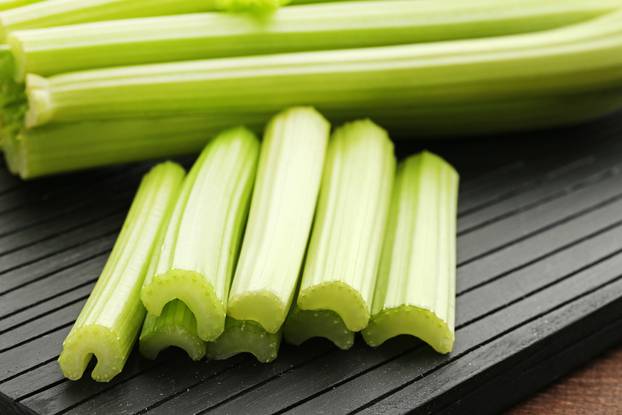 Celery on black cutting board