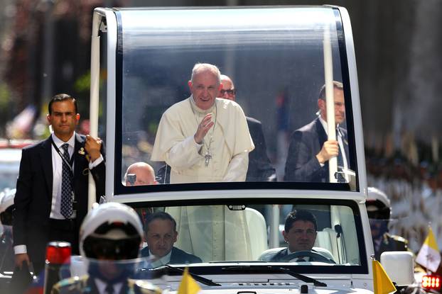 Pope Francis waves to the crowd while arriving to the Cathedral of Santiago, in Santiago,