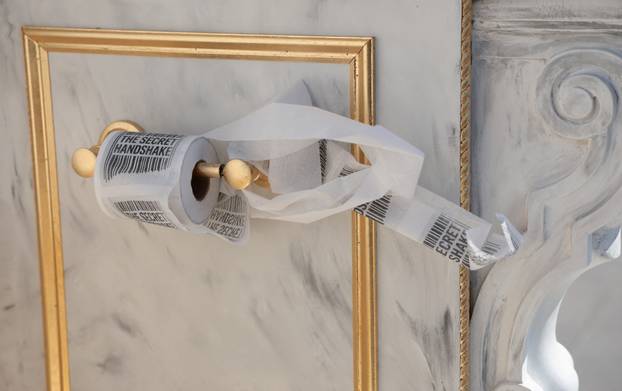 A statue featuring a large golden toilet, titled "A Throne Fit for a King," is displayed in Washington