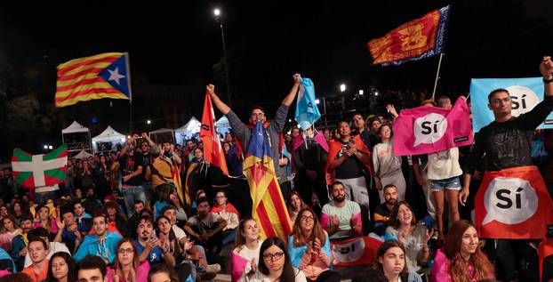 People react as they gather at Plaza Catalunya after voting ended for the banned independence referendum, in Barcelona