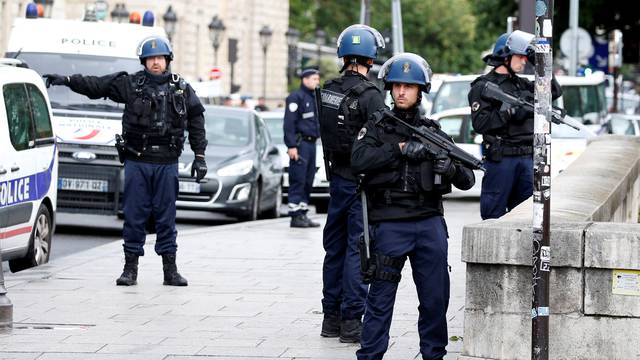 French gendarmes and police stand at the scene of a shooting incident near the Notre Dame Cathedral in Paris
