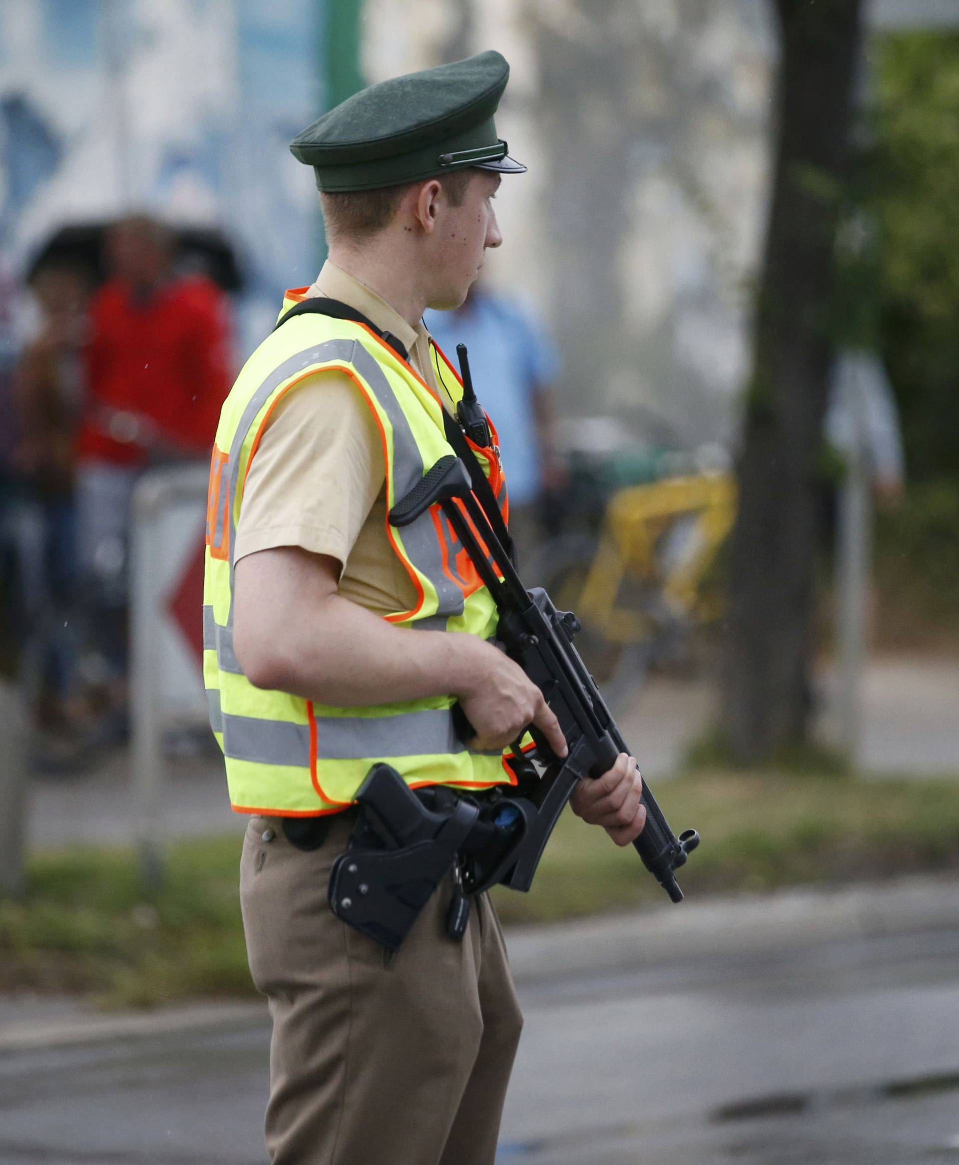 Police officer secures road near to scene of a shooting rampage in Munich