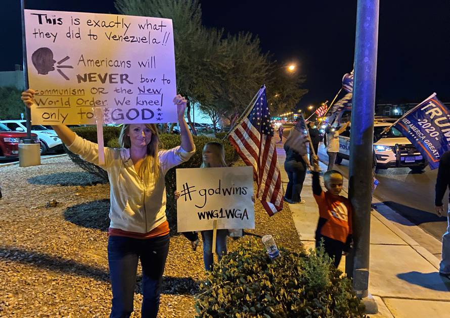 A protester supporting U.S. President Donald Trump holds up a sign outside the Clark County Elections Department where ballots are being counted in Las Vegas