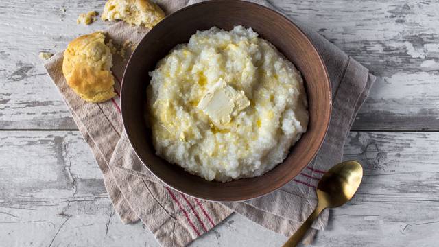 Buttered,Grits,With,Biscuits,In,Rustic,Setting,Top,View