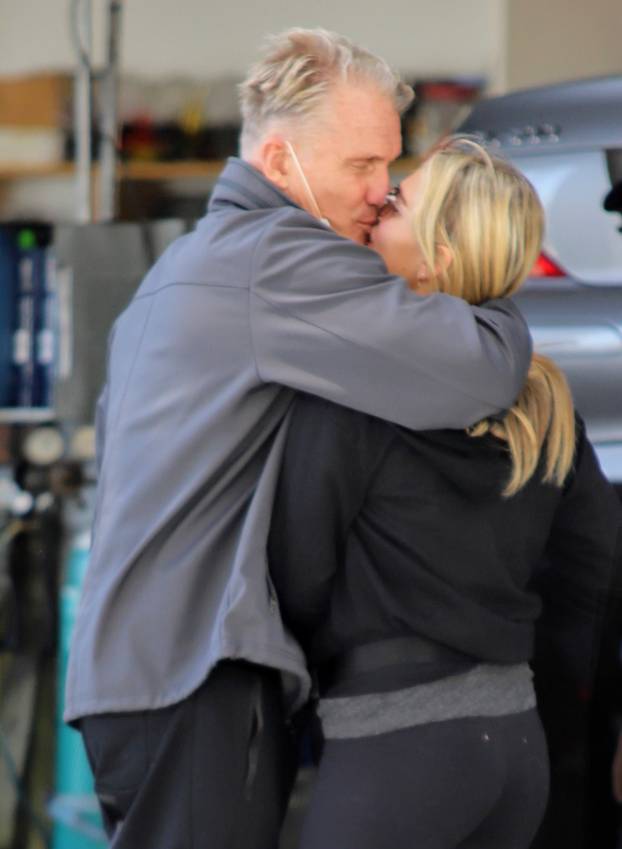 EXCLUSIVE: Dolph Lundgren 62 and his 40 years younger fiance Emma Krokdal pull in for a quick tune up and some PDA while wearing a shirt that mentions him and Rocky cast