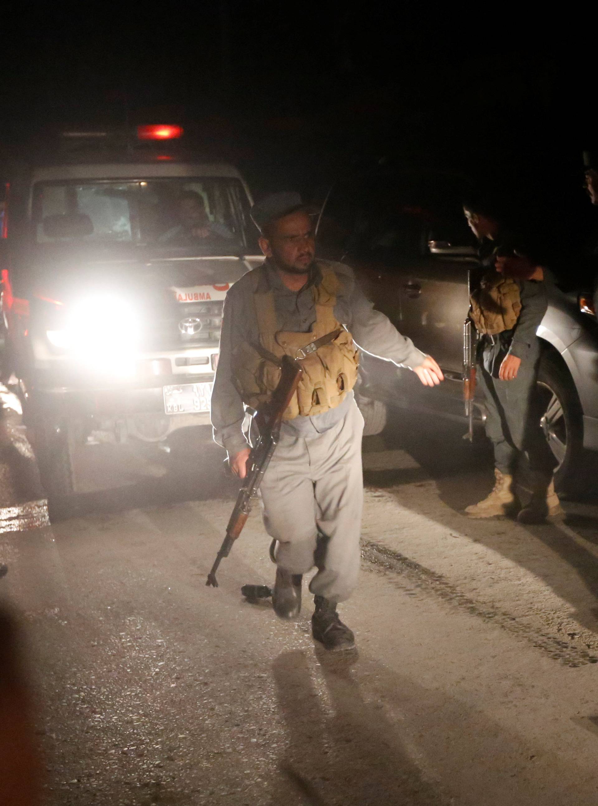 Afghan policemen stand guard at the site of an attack at American University of Afghanistan in Kabul