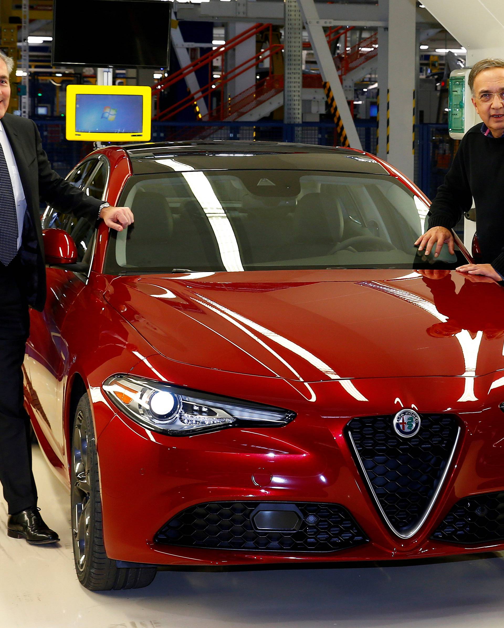 FILE PHOTO: FCA CEO Sergio Marchionne and Alfredo Altavilla Chief Operating Officer EMEA pose next to the new Alfa Romeo car Giulia during an event at an FCA plant in Cassino