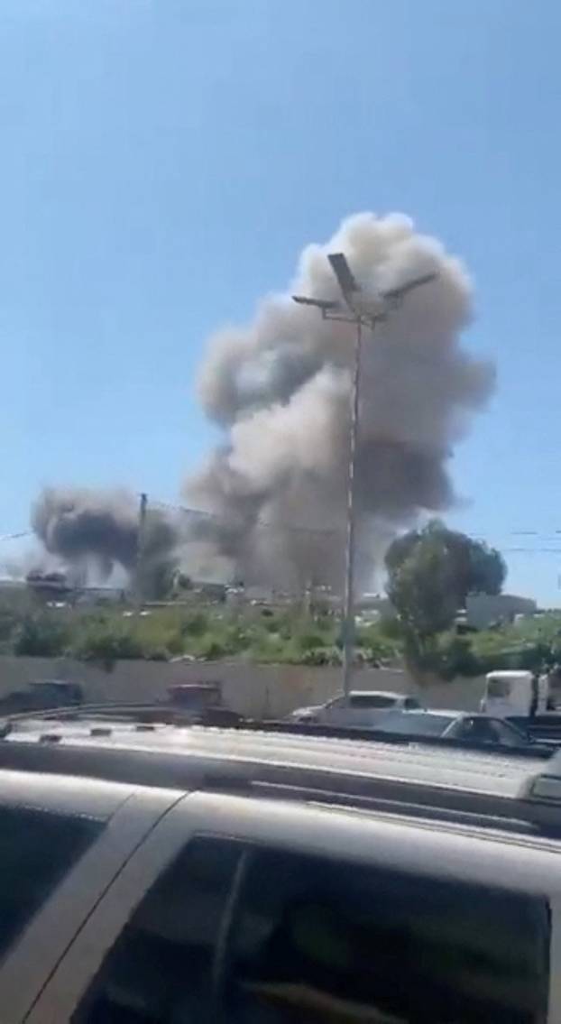 Smoke rises following Israeli strikes, near the airport in Beirut