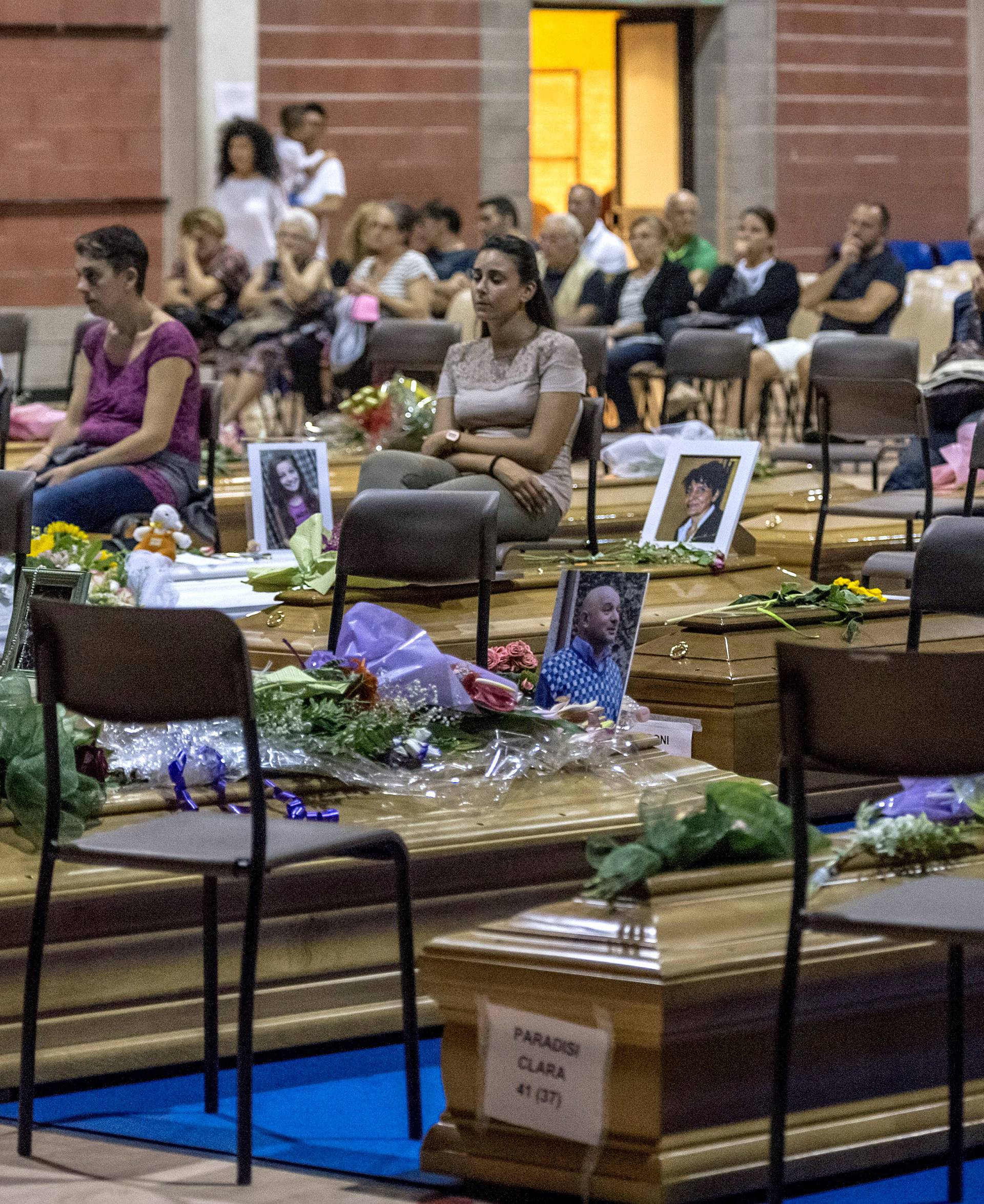 Coffins of some of the victims of the earthquake in central Italy are seen inside a gym in Ascoli Piceno