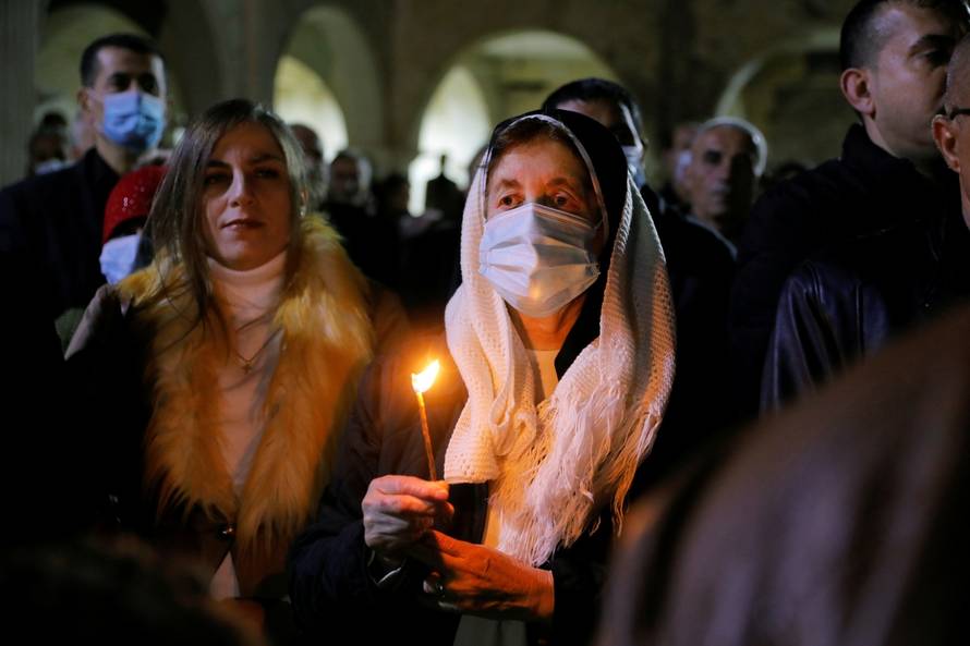 Iraqi Christians hold a mass on Christmas Eve